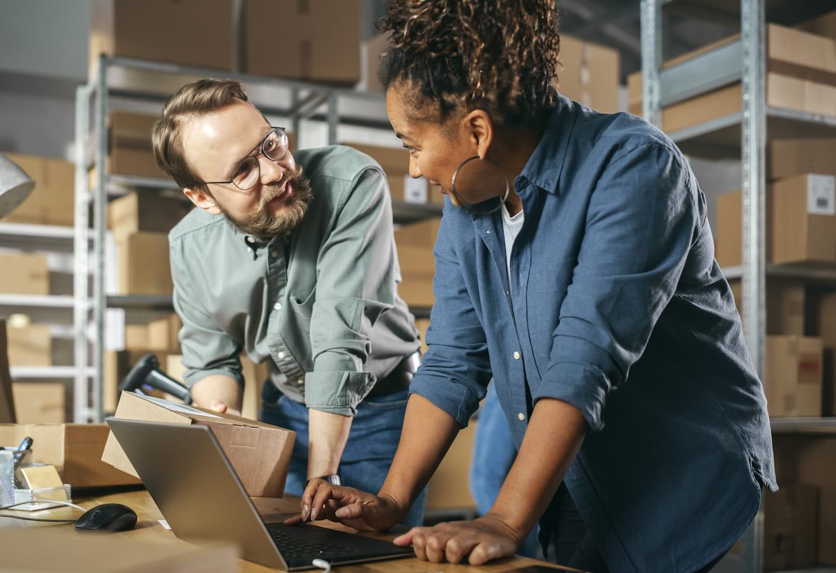 Male and Female Working in Warehouse Preparing Shipment