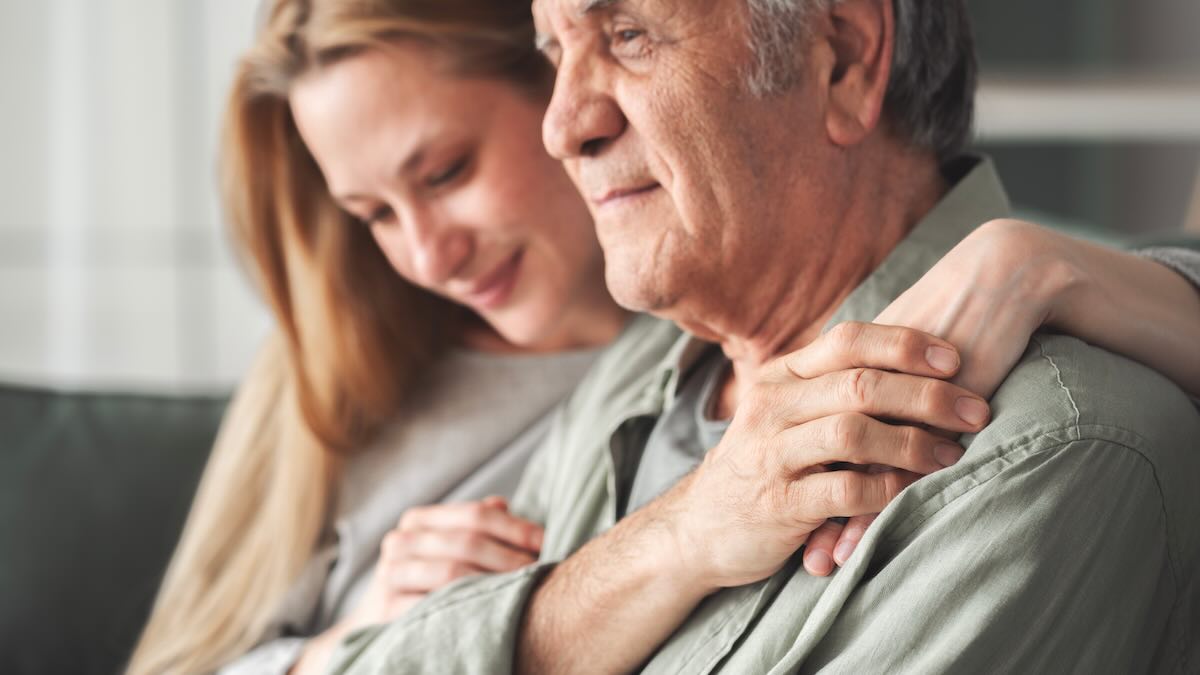 Grown woman comforting her father 