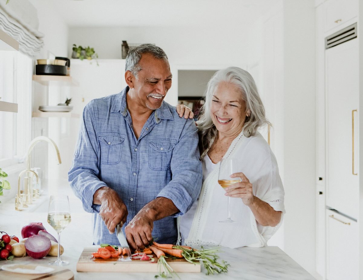 Retired couple cooking at a kitchen 