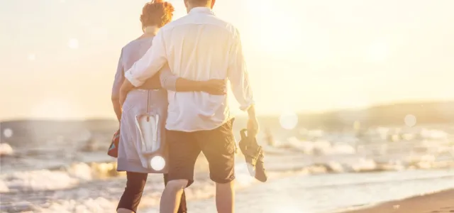 Close-up portrait of an elderly couple hugging on seacoast